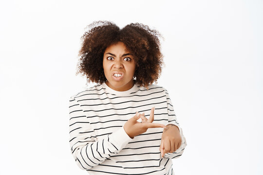 Hurry Up. Annoyed African American Girl Pointing At Her Wrist Watch And Looking Pissed-off, Being Late, Standing Over White Background