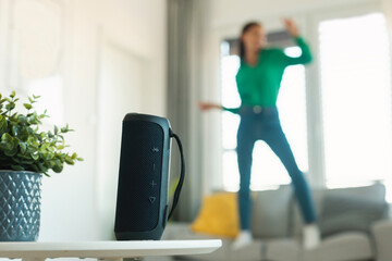 Unrecognizable Lady Listening Music Via Music Speaker Dancing At Home