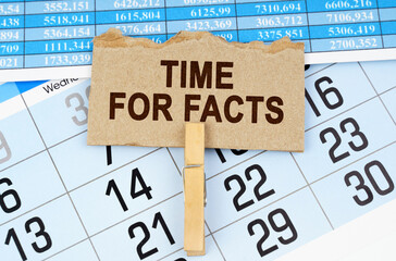 On the calendar and reporting documents is a cardboard plate with the inscription - Time for Facts