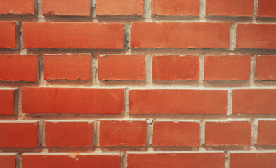 a frontally removed red brick wall. Textured background