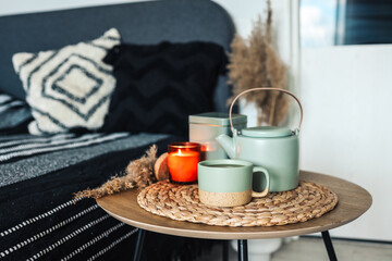Bedroom decorative objects on the bed in cozy vintage bedroom. Two cups of tea and a ceramic teapot. Home decoration concept