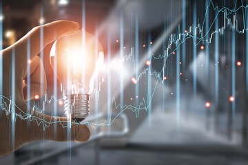 Hand with a light bulb and graph of crisis concept