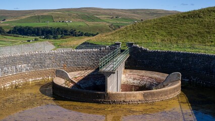 Burnhope reservoir with green mountains in the background, England.