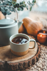 Cup and teapot in Scandinavian style on a wooden tray