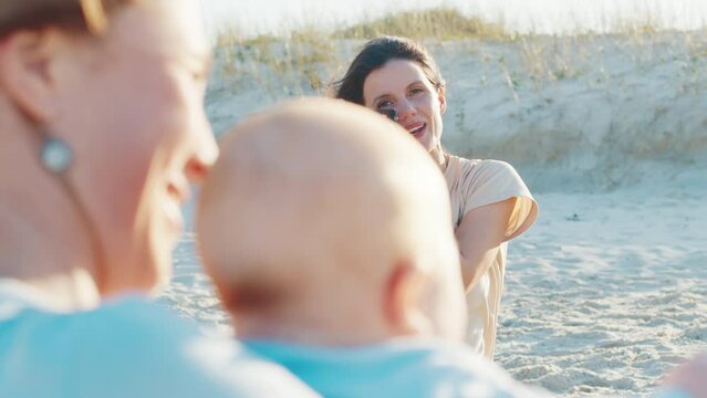 Family photographer. Cheerful woman takes pictures of the woman with kids
