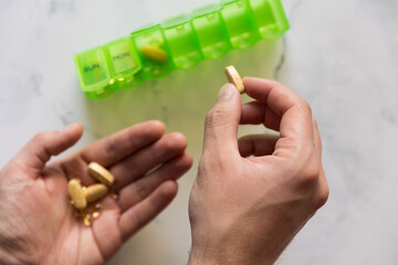 Man using a pill box organizer