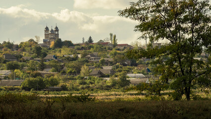 village autumn landscape Olanesti Moldova Church house tree hill