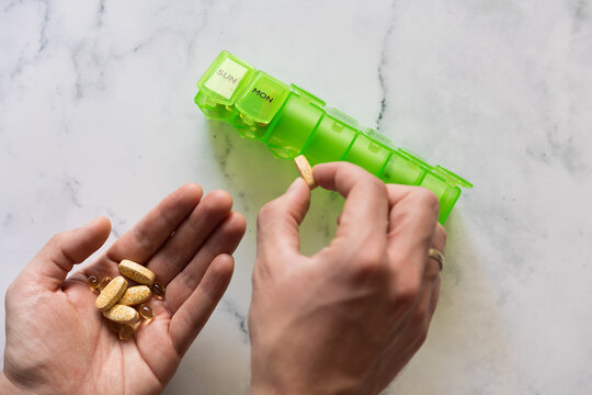 Man using a pill box organizer