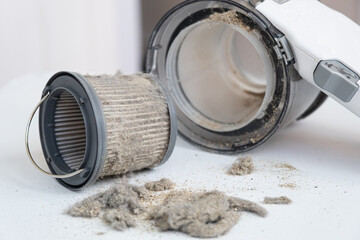Dirty vacuum cleaner filter. The miniature vacuum cleaner has collected a lot of dust and debris