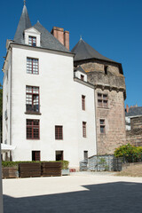 Fototapeta na wymiar Ancient tower and white building. Castle in Nantes, France