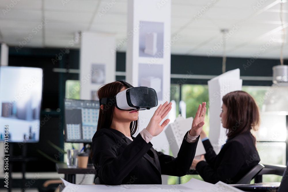 Poster architect in vr headset working on project in metaverse. asian employee engineering in architecture 