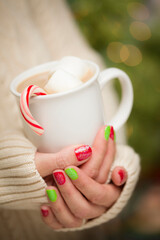 Woman with Red and Green Nail Polish Holding Mug of Hot Cocoa