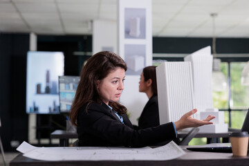 Architect discussing building prototype on videocall in architecture office. Employee talking about architectural design on videoconference, 3d printed model online presentation.