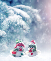 Merry Christmas and happy New Year greeting card with copy space.Two snowmen standing in snow. 
