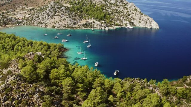 Aerial view of boats and yachts in a beautiful bay of the mediterranean sea. Cennet Bay, located in Selimiye village of Marmaris District of Mugla City, Turkey.