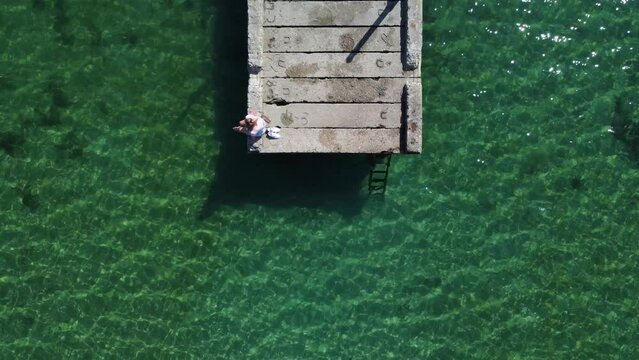 Aerial view of a wooden dock over the Lake of Pogradec in Albania
