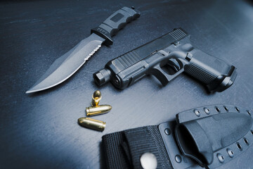 Large knife and gun, close-up photo.