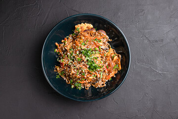 Wok, wok noodles with different fillings on a black background