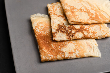 Pancakes, pancakes with different fillings on a black background