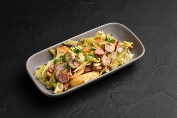 Salad with sausages, fresh salad with sausages and on a black background