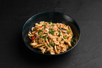 Wok, wok noodles with different fillings on a black background