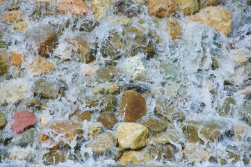 Colored stones along the shore of the pacific ocean Malibu California