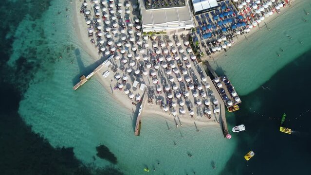 4K aerial video panning over the beautiful vacation coast and blue water in Ksamil, Sarande, Albania