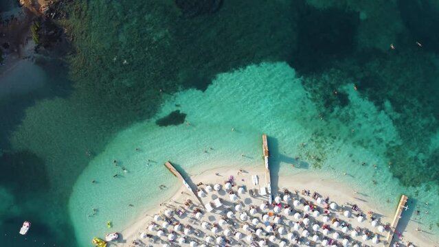 4K aerial video panning over the beautiful vacation coast and blue water in Ksamil, Sarande, Albania