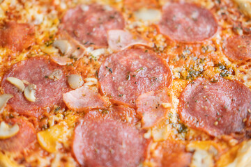 Hot meat pizza with salami, bacon and cheese. Selective focus.