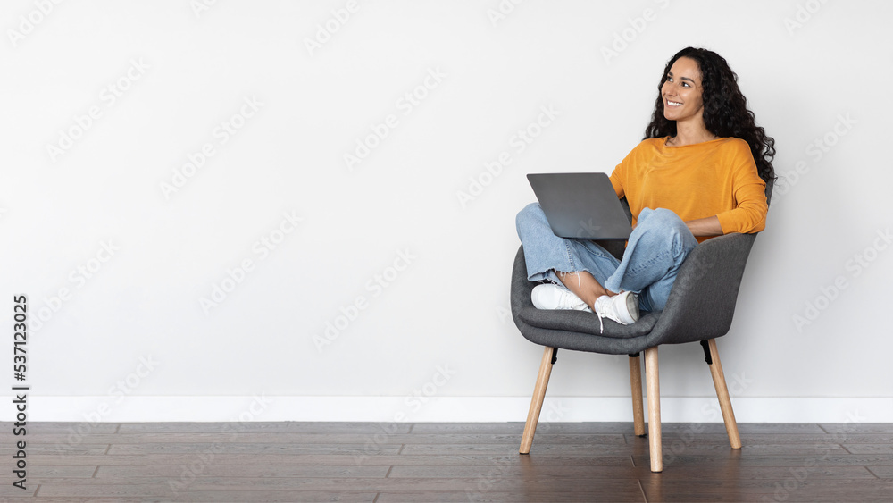 Wall mural cheerful young woman freelancer using laptop at home, copy space