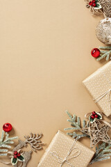 Merry Christmas vertical background with craft paper gift boxes, fir branches, red balls on beige...