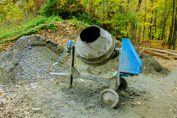 Industrial concrete mixer at construction site. Preparation of concrete mortar
