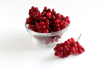 Champagne Grapes also known as Black Corinth or Zante Currant in a bowl with white background. 