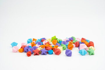 Scattered small origami stars of various colors