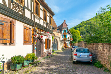 Colorful medieval half timbered medieval homes line  the streets and alleys near the Weiss river canal in the historic town center of Kaysersberg Vignoble, France in the Alsace region.