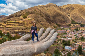 A woman at the Mirador de Cielo Punku viewpoint in Huaro, Cusco, Peru. This viewpoint consists of...