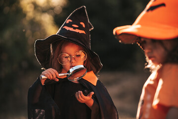 two little girls of three years old celebrate Halloween in nature
