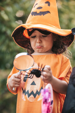 little girl celebrate Halloween in nature pumpkin