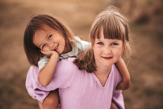 Two sisters , close up portrait in nature