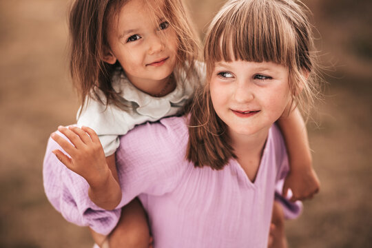 Two sisters , close up portrait in nature