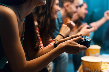 Cheerful friends playing video games together