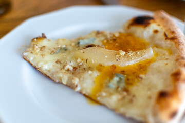 Eating of fresh baked pizza dish in italian pizzeria restaurant