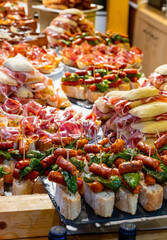 Typical snack of Basque Country and Navarre, pinchos or pinxtos, small piece of bread with...