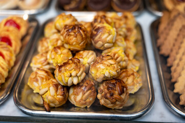 Variety of cookies and cakes on display in artisanal bakery in San Sebastian city, Basque Country, Spain