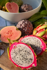 Variaty of tropical exotic fruits, ripe fresh lychee, dragon fruit, guava and cherimoya
