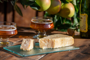 Cheese pairing with drinks,  parmigiano reggiano or parmesan cheese and French apple cider served outdoor