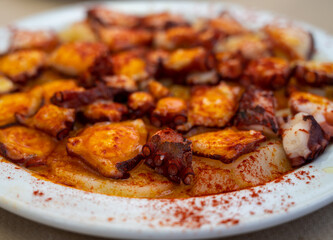 Tasty seafood, grilled octopus galician style with red pimento paprika and potatoes
