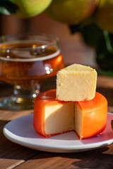 Food and drink pairing, apple cider produced on organic farm from bio apples in Normandy, France and cheddar cheese from England