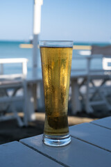 Pint of cold lager beer served in sunny beach bar on Cyprus