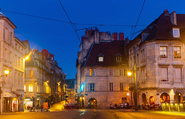 Fototapeta na wymiar Evening view of illuminated lively historic center of French city of Besancon in summer.
